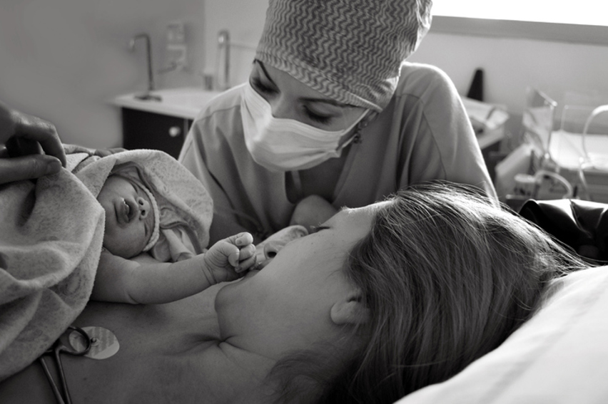 Midwife delivering baby